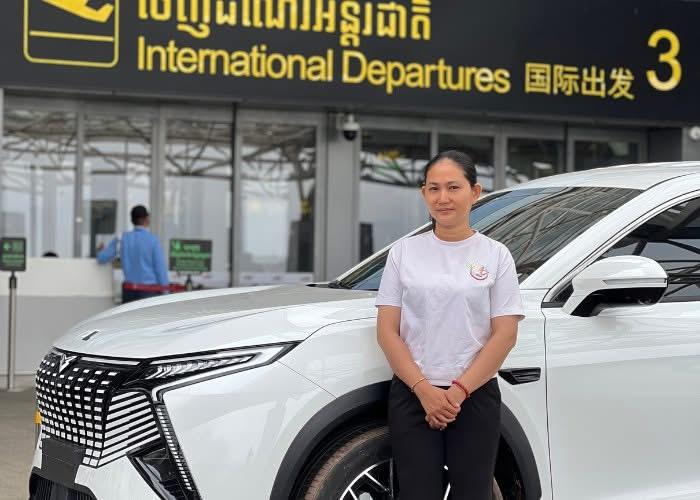 Isa, founder of Angkor Lady Drivers, standing beside her tuk-tuk in Siem Reap